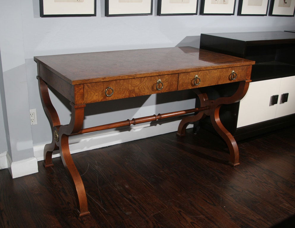 Elegant walnut burl-topped desk on clear walnut base with brass drop-pulls and mounts