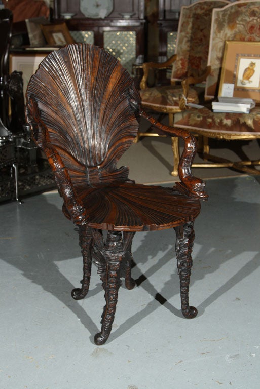 A Thomas Chippendale design of a Grotto chair carved in walnut.  Probably Italian.