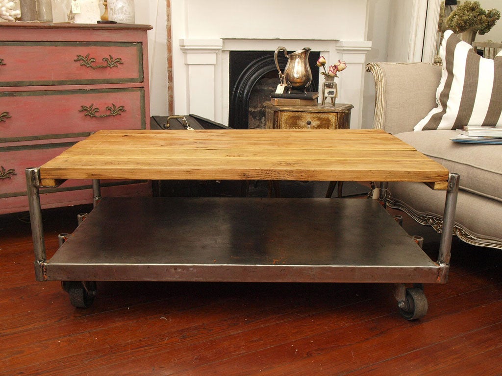 Beautiful, rustic, industrial metal cart with plank table top.  Very sturdy and heavy.  Working wheels are stable and perfectly balanced.  Perfect patina to both the wood and metal portions.