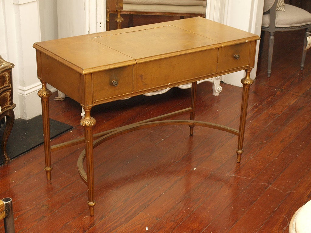 Absolutely breathtaking antique piece. Hand-crafted in gold leaf with just the perfect original patina. Can be used as a desk or vanity or just admired simply for its uniqueness and beauty. Two small drawers on each side with storage under desk lid.