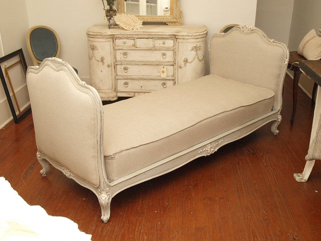 French Antique Daybed (early 1800s) completely restored with custom mattress. Mattress and frame reupholstered in a natural belgian linen. We added a flange around the mattress for a tailored look with ruffles on the corners to satisfy even the most