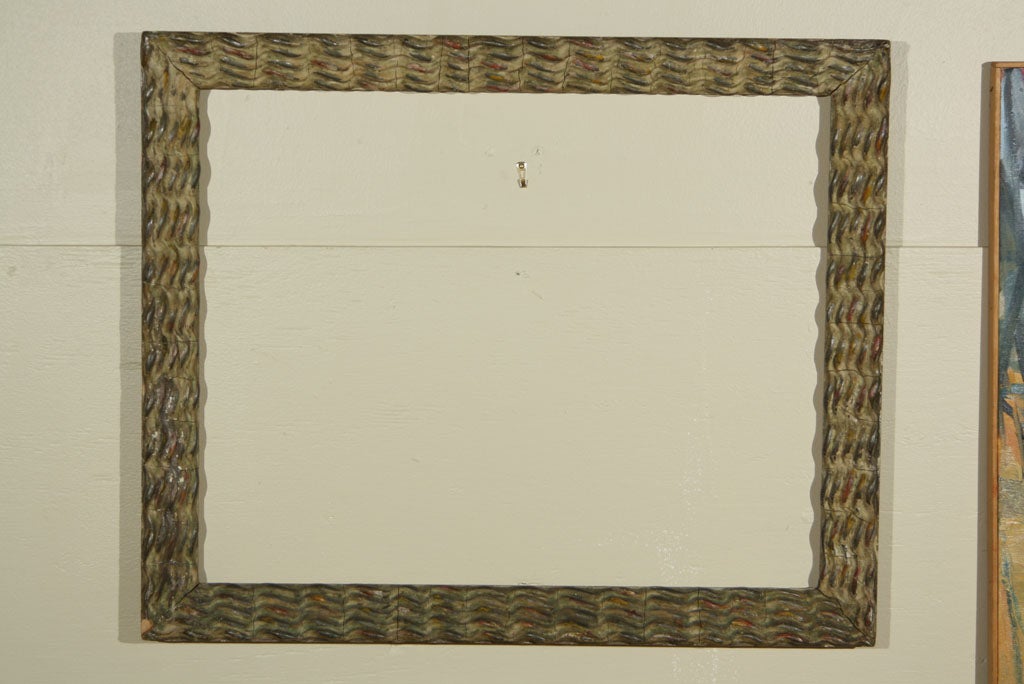 An extremely rare and important Modernist frame by Newcomb-Macklin.  Dating to the 1930's, this frame has a rippled and polychromed gesso design.  There is a small piece missing from the bottom left hand corner.  The gesso shows various cracks