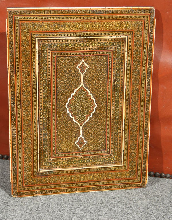 An antique Persian mirror frame Khatamkari.  This work dates to the late 19th or early 20th Century.  <br />
<br />
Khatamkari is one of the Persian arts of marquetry in which the surface of a wooden or metal article is covered in a micro-mosaic