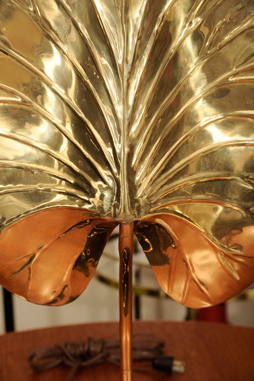 A very decorative brass, mid-century table lamp by Tommaso Barbi, circa 1950. The lamp is in the shape of a large lotus leaf. The lamp gives out a beautiful light to set the mood in your room.
