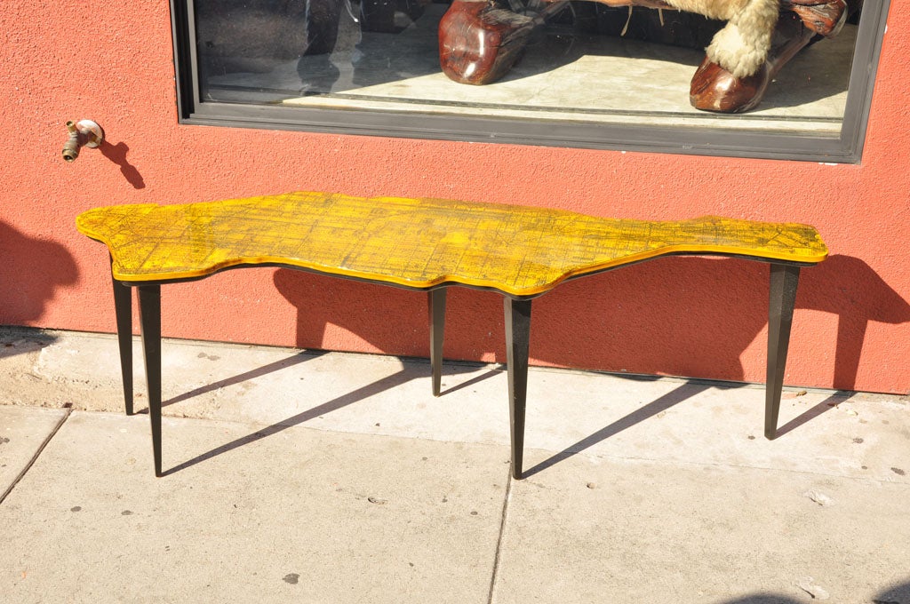 A map of Manhattan coffee table by Venice of California artist and furniture craftsman Doug Edge consisting of a map printed on a birch plywood top which has been then cut to the contours of the  borders and set on wood tapered legs. The map is