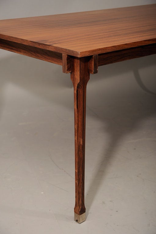 A rare dining table by Luisa & Ico Parisi with the label of the producer Mobili Italiani Moderni. The rectangular top on a defined neo-liberty stile four leg construction with adjustable metal feet. Beautifully aged and faded rosewood with excellent