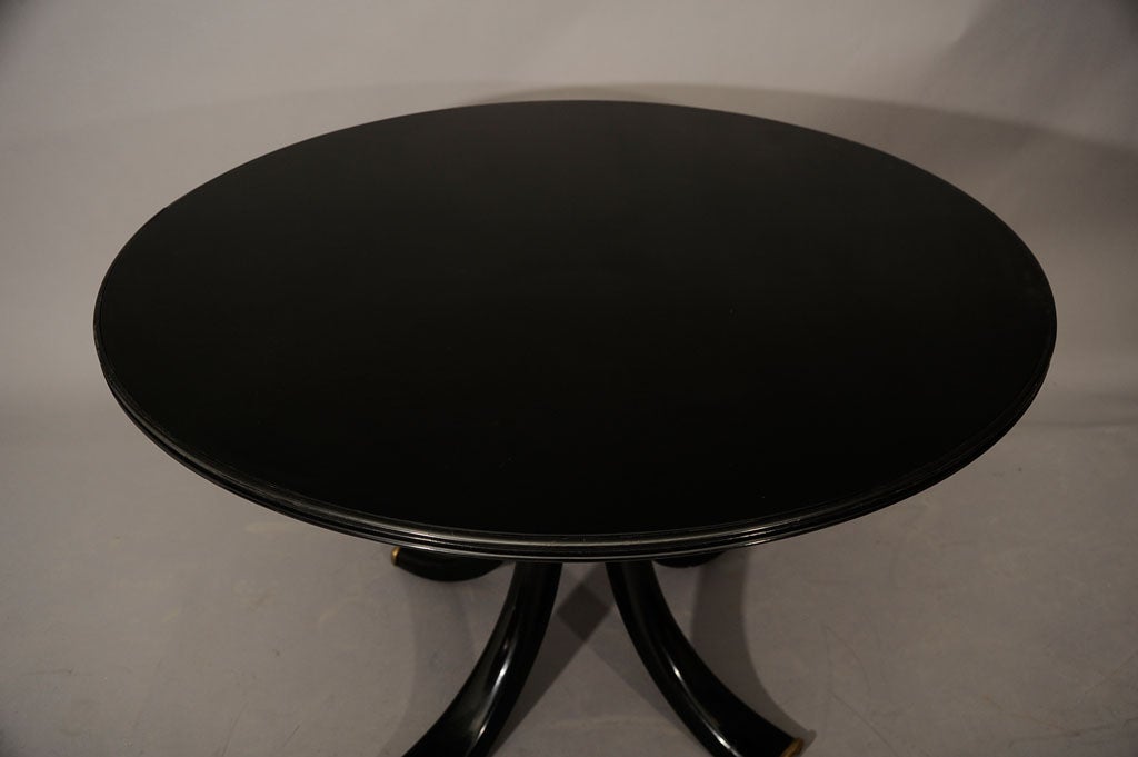 A large black glass dining table by Osvaldo Borsani.<br />
<br />
Published in: Gramigna, Giuliana and Irace, Fulvio, Osvaldo Borsani, Roma, 1992