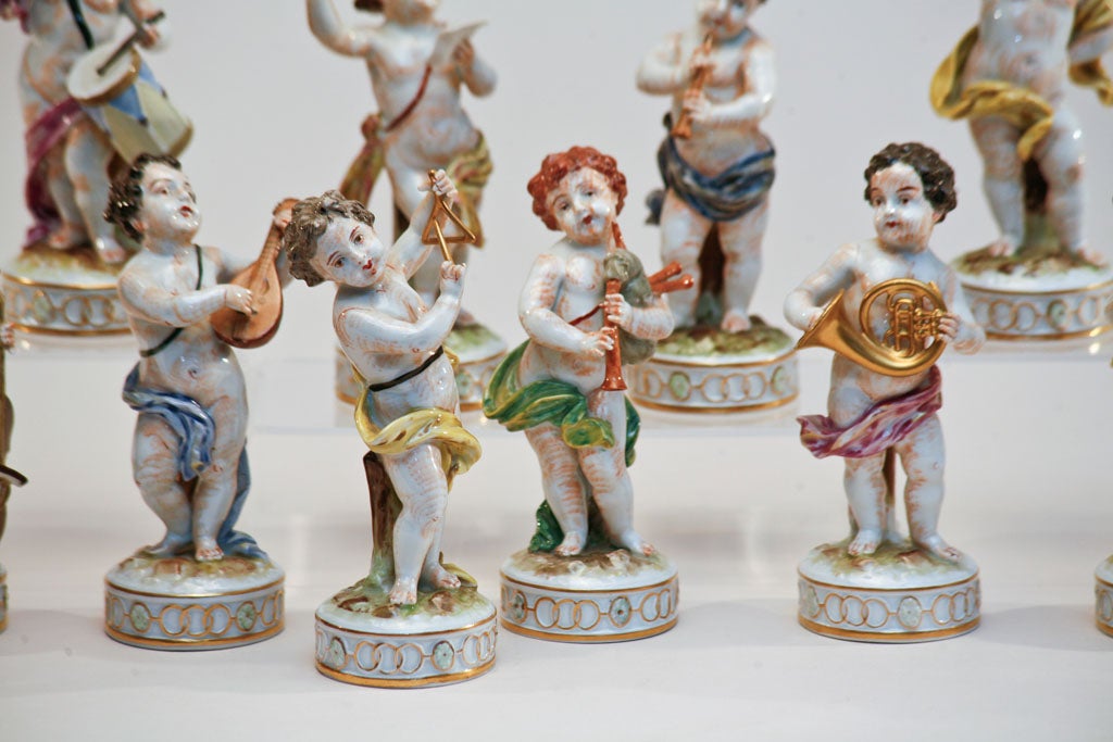 Set of 10 hand painted Putti figurines depicting musicians each playing a different instrument including the  conductor, flautist, triangle  player, drummer etc. Each figure is beautifully molded and detailed with hand painted polychrome decoration.