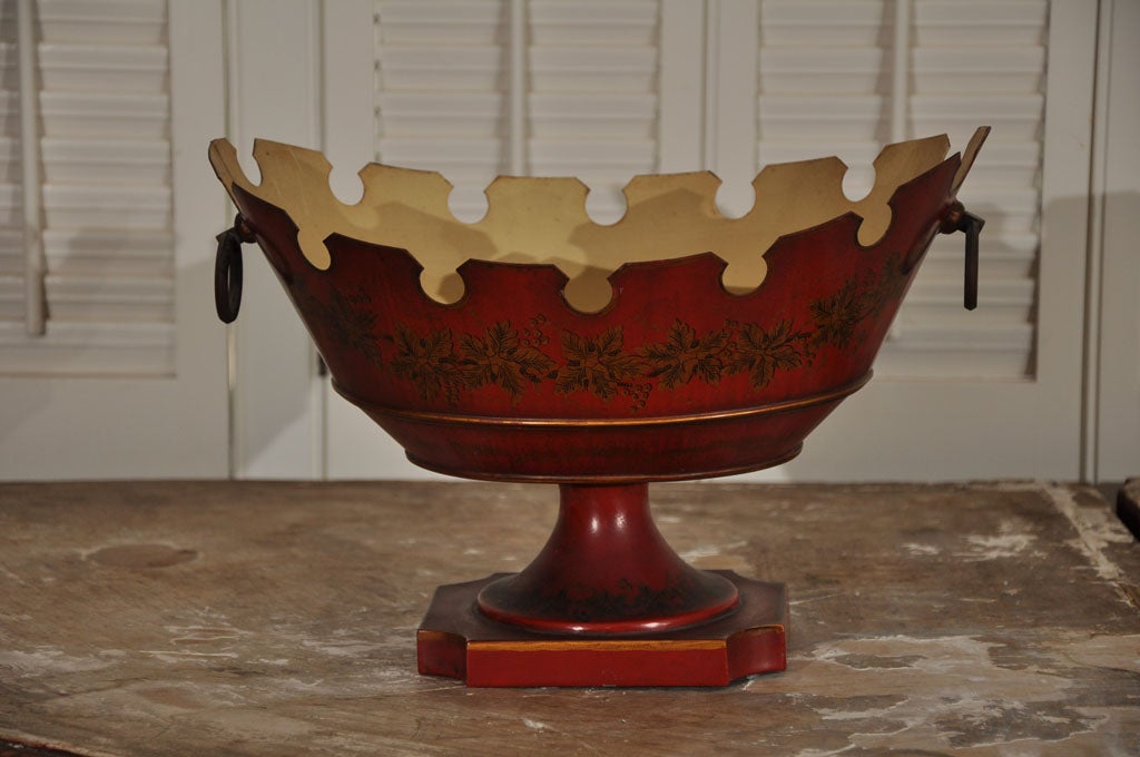 Circa 1940 red and gold French centerpiece bowl with oval shape and scalloped edges. Grape leaf motif decoraton encircles the piece and rings are at each end. Interior in original cream paint. Signed om bottom 