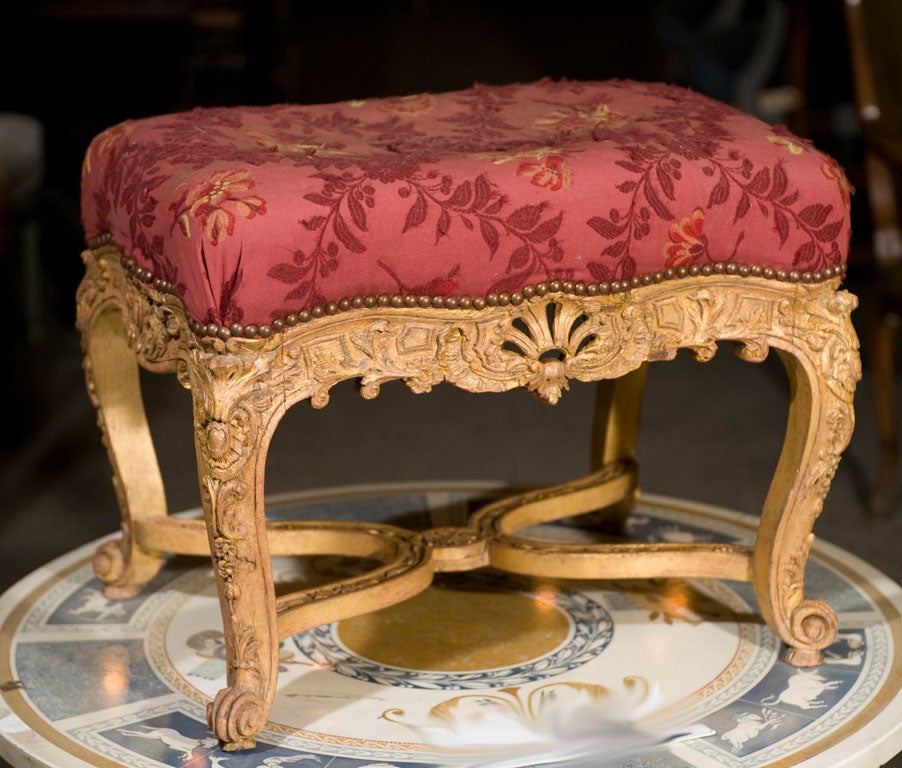Elaborately carved and gilt French Louis XV style footstool.