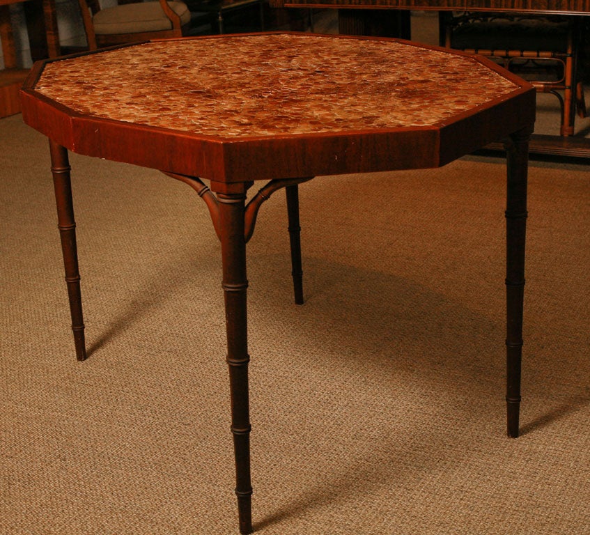 Here is a table with a pebble mosaic polyhedron shaped top.<br />
The base is made of walnut and has bamboo motif legs. <br />
This would make a great games table or tea table.