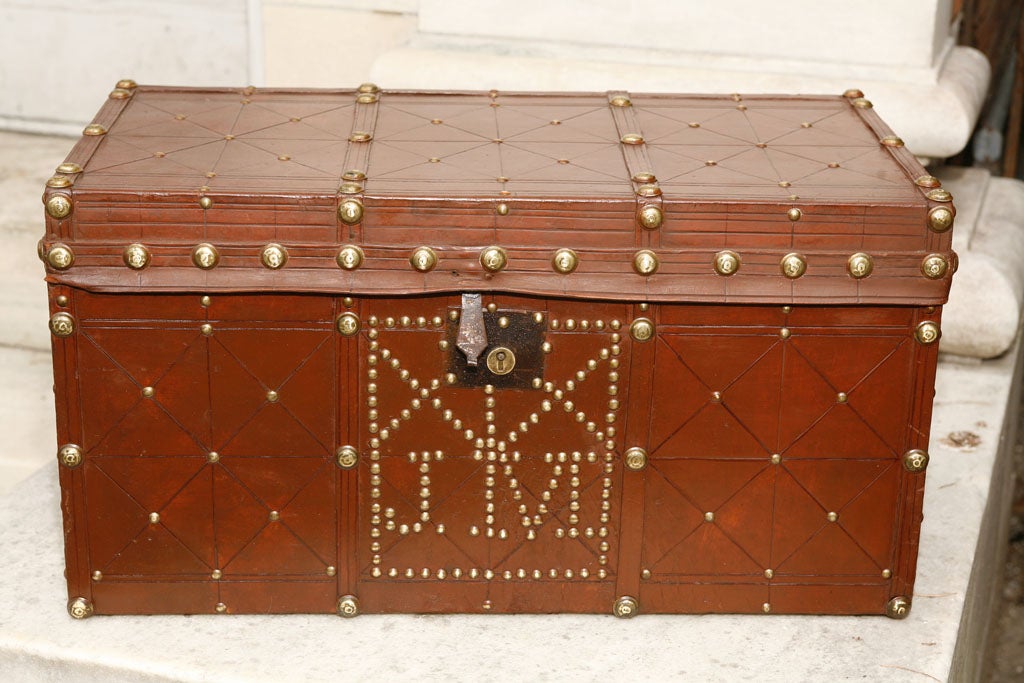 This brass studded leather trunk in an unusual small size would be useful in many applications. Perfect on a stand at the end of a bed it would also work well as a small end or coffee table as it is finished in the round and is in almost perfect