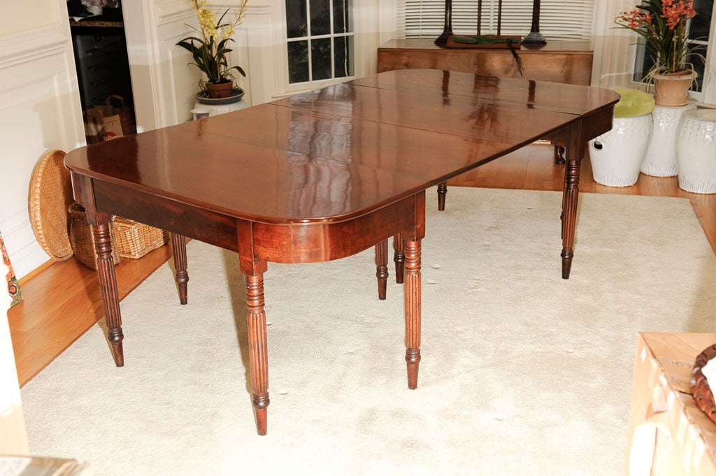 Two part Mahogany banquet table.  From the Lee-Fenton Mansion Alexandria Va.
Each D-formed top raised on turned and reeded legs which terminate on a ring and spike foot. Each console open is 42