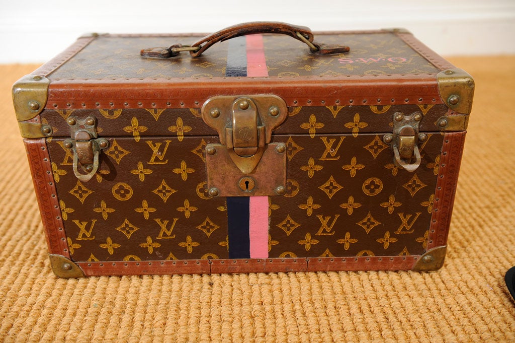 Vintage French Louis Vuitton leather and canvas suitcase with the reinforced brass corners and latch. The exterior with the LV monogram canvas with the leather trim stamped with the LV logo. The interior with tray, mirror, buff colored canvas.