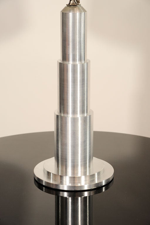 This brushed aluminum lamp exemplifies the machine Age influence on Art deco in America. Newly rewired and fitted with a beautiful new shade. Would be great on a mens desk as well.
