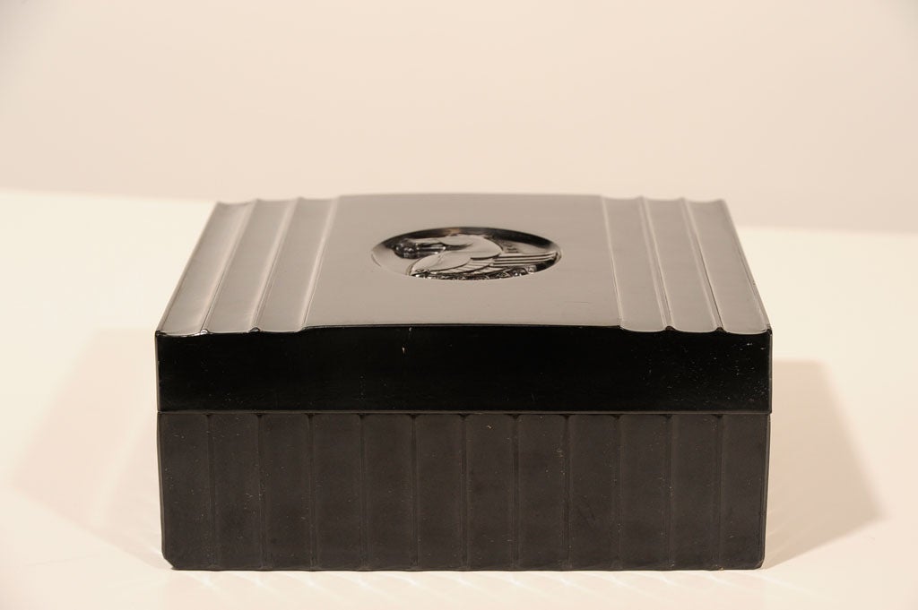 This beautiful bakelite box features fluted detailing with a stylized Art Deco Pegasus on the cover. This would be great as a mens jewelry box or valet. Also great on a cocktail table to put remotes in or on a console table for wallet,keys etc.