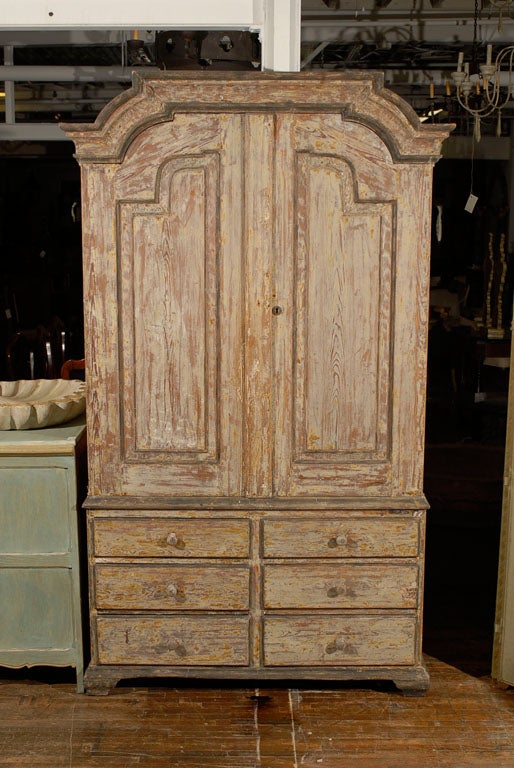 A Swedish period Rococo cabinet, two doors over six drawers, dry scraped to the original paint, nice pediment, circa 1760.