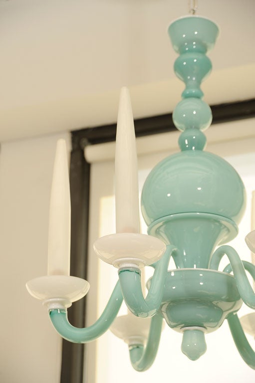 with six 'S' shaped arms, supporting sconces and vertical tapering glass shades.