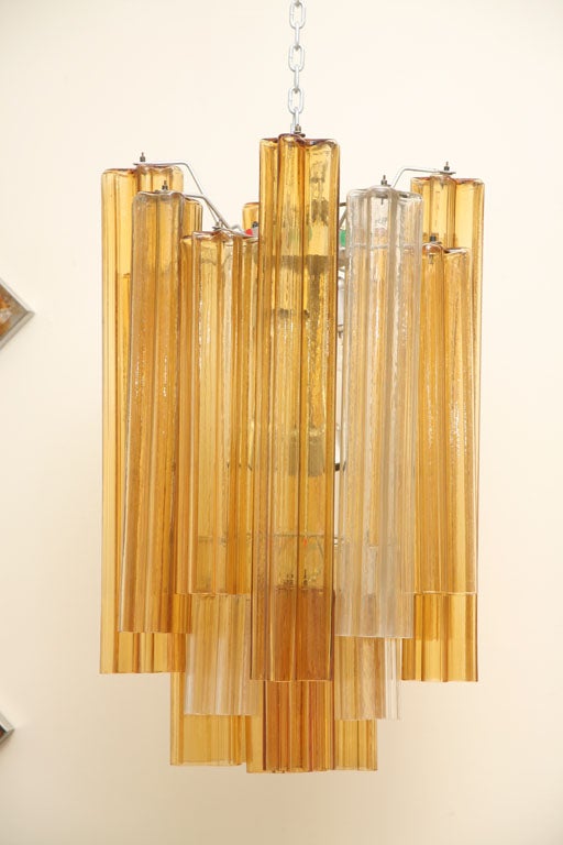 Mid-Century Modern Italian Chandelier with 19 handmade heavy tubular blown glass ornaments in clear and amber colors.
Made by Venini and styled after Barovier & Toso.
US Rewiring and in perfect working condition. Takes 19 E14 candelabra light bulbs