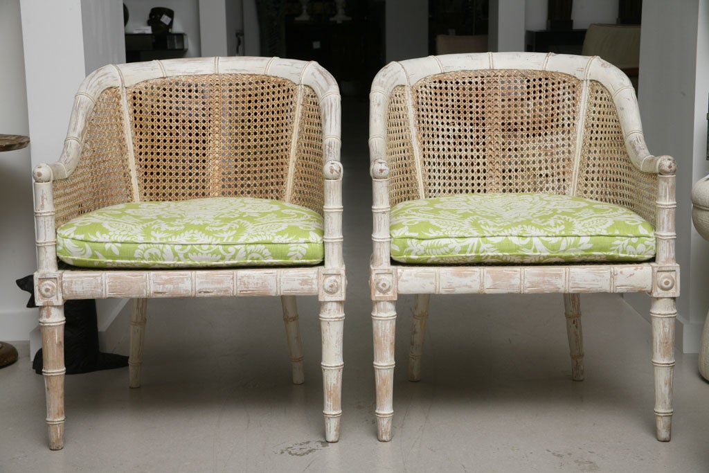 Pair of vintage Palm Beach style chairs with cane detail and wood armature.