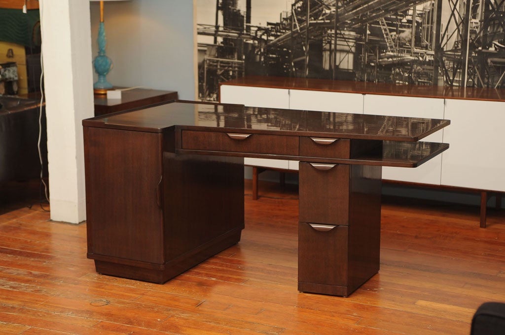 Angular desk designed by Edward Wormley for Dunbar furniture co. Made from solid mahogany and open on both sides, drawers with fitted interiors. Completely restored in bittersweet chocolate finish and labeled.

Price reduced from $8800.00 to