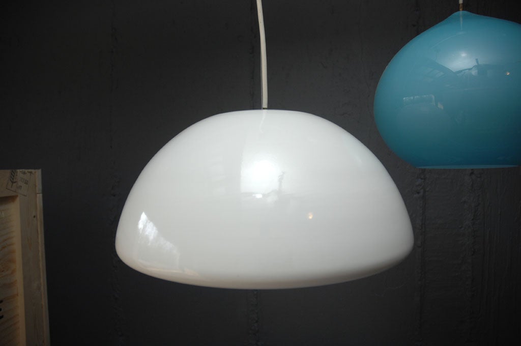 This pendant light was designed by Elio Martenelli for Martenelli-Luce in the early 1970s.
The shade is made of opaline glass and it has an aluminium inset reflector, made in Italy.
Never used.