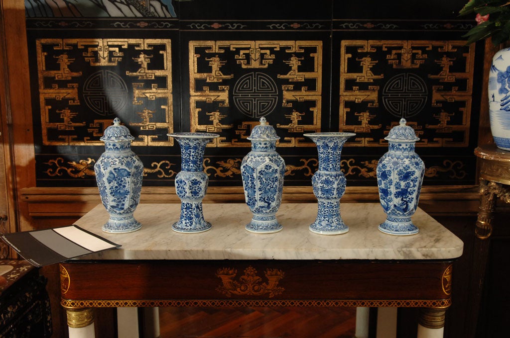 Chinese export blue and white Kang Hsi period garniture set, comprised of two trumpet shaped vases and three lided urns.
