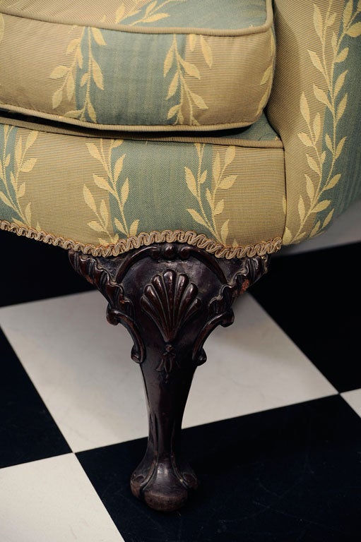 Irish Georgian mahogany wing chair with cabriole leg, shell carved on knee.