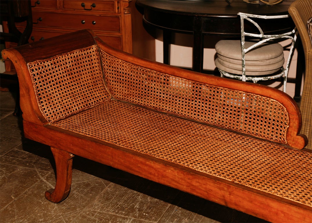 Continental fruitwood lounge with a scrolled back and saber legs.<br />
<br />
keywords:  chaise longue, settee, bench