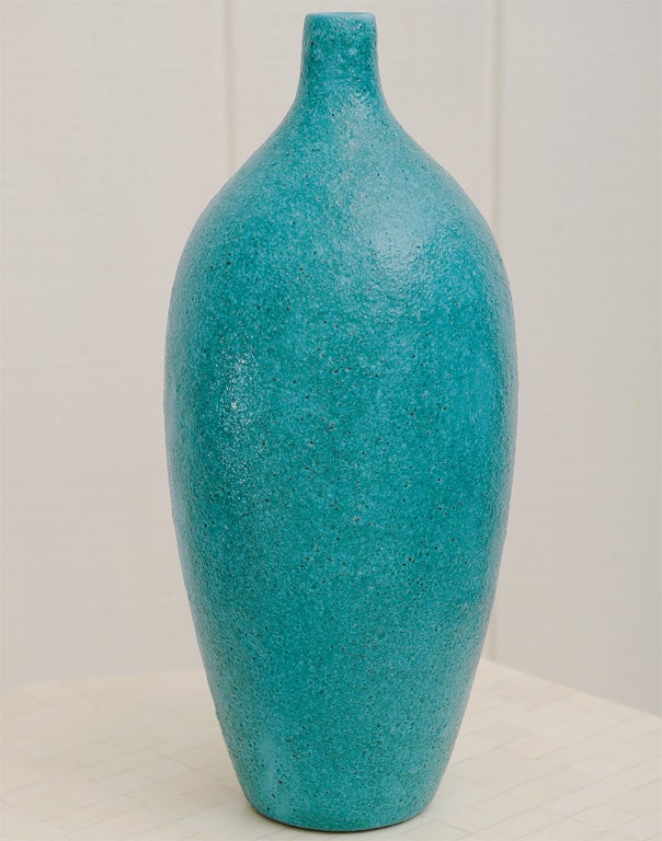 Wonderful tall Italian deep vivid turquoise pottery bottle form vase covered in a lava glaze and attributed to Guido Gambone.  This example is unsigned.  Color is rich and intense, and lava glaze has wonderful mottled texture and depth.  A fabulous