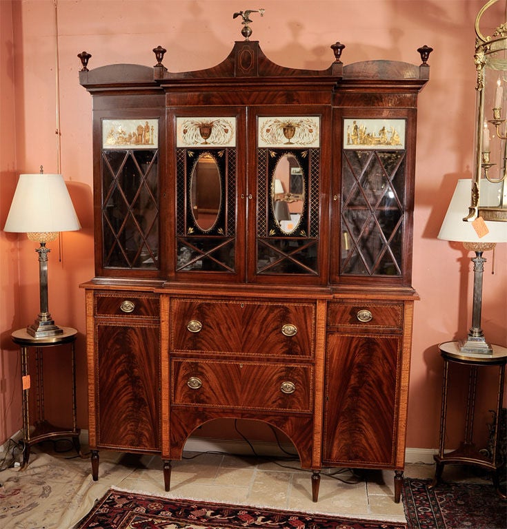 Salem, Massachusetts mahogany satinwood inlaid Butler's breakfront bookcase with rare eglomise panels.
