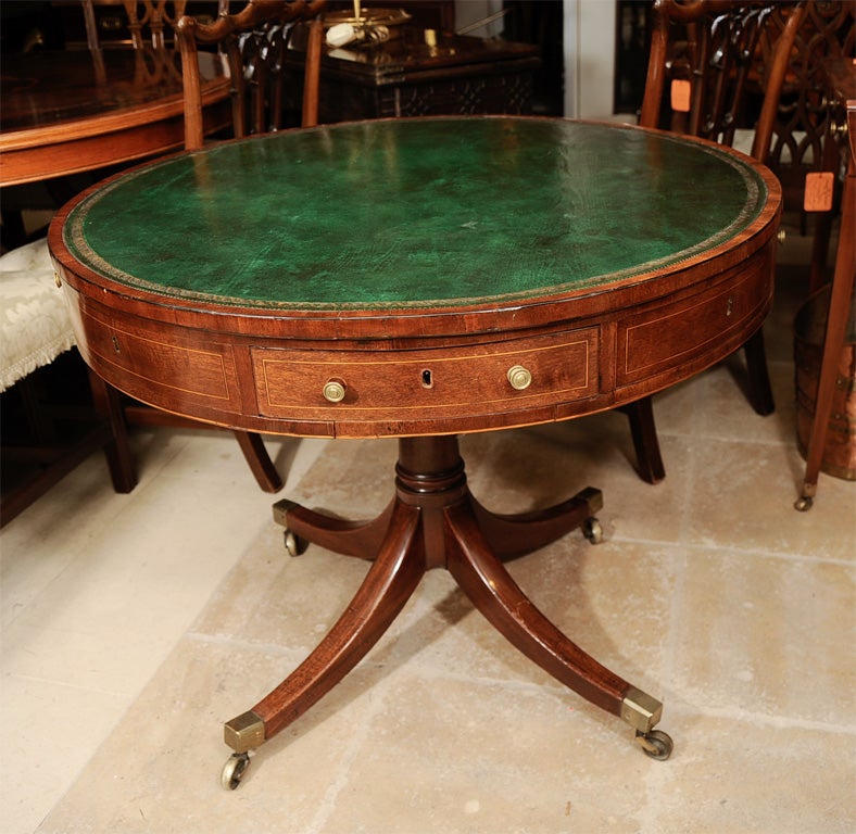Regency mahogany satinwood inlaid leather top drum table with cedar lined drawers.