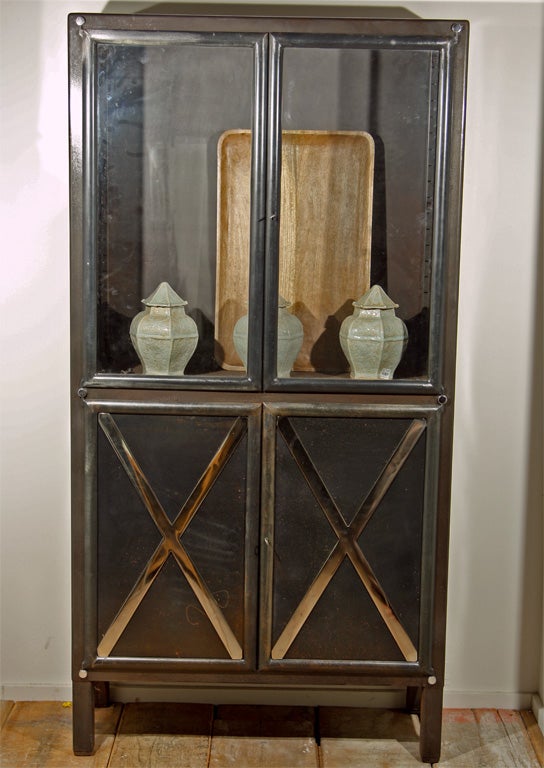 French 4 door steel cabinet, the upper section  with glass panels and the lower in a natural steel finish with polished steel x-inserts detail, c. 1930