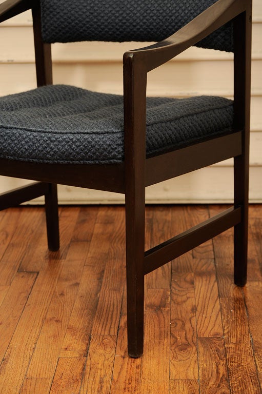 Pair of dark stained mahogany armchairs by Ray Zimmerman for Dunbar with tufted seat and original steel gray/blue upholstery, circa 1960's. Both have the original maker's paper label that reads: 
