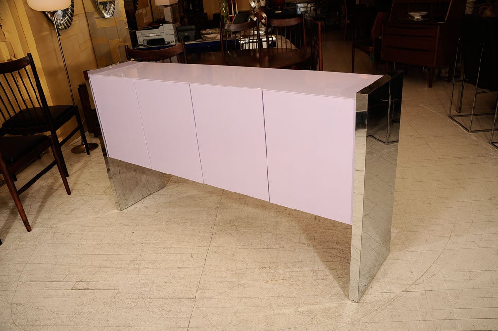 Beautiful lavender lacquered credenza with chrome cladded side supports. Located at ABC Carpet & Home, 212-473-3000, ext. 519