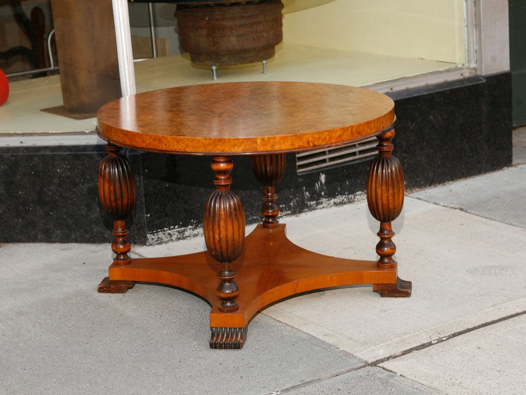 Occasional table, with a finely figured burlwood top, quatrepod base with 4 turned and carved column supports.   Could be used as coffee table.  lamp table or side table.