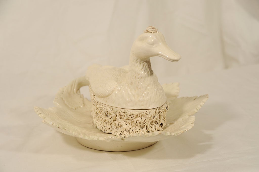 A Creamware tureen in the form of a duck sitting on a nest.<br />
The nest is built on a leaf (which can be seen clearly in image #9).<br />
The leaf is a typical form of 18th century English Creamware, but the duck on its nest is quite rare. The