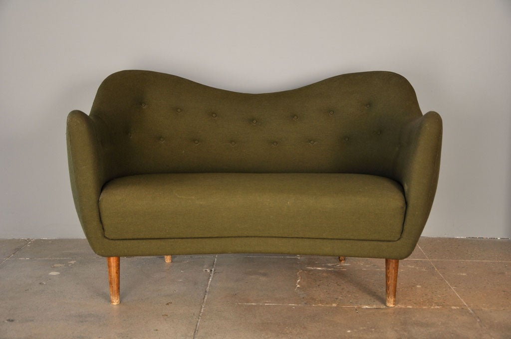 the classic finn juhl sofa originally designed in 1946 was inspired by the work of picasso. this was produced in 1952 and has been re-upholstered along the way. the green of the sofa is much darker than the images published.