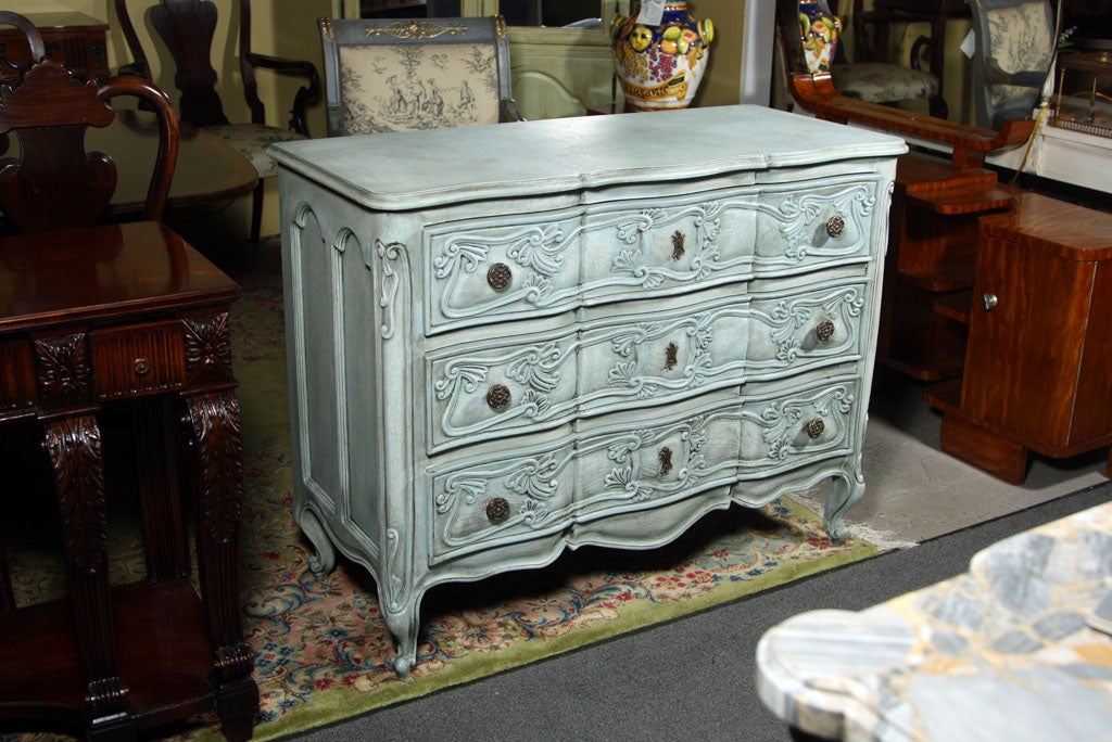 Wonderfully decorated custom painted  three-drawer chest. The sides and fronts finely carved having three drawers sitting on Louis XV feet. Solid wood. 

