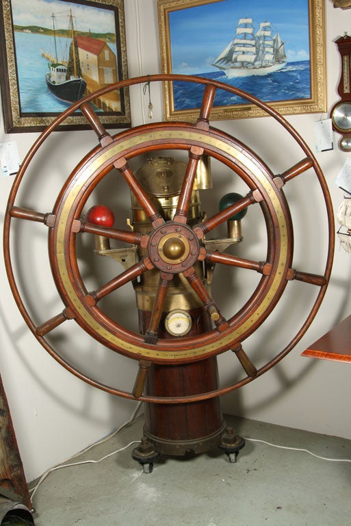 A beautiful turn of the 20th century, museum quality British ship's helm. The unit is complete with oil burner, skylight, fiddlers tube, navigator's balls, inclinometer, access doors w/key, & fully functional original liquid filled compass. Made of