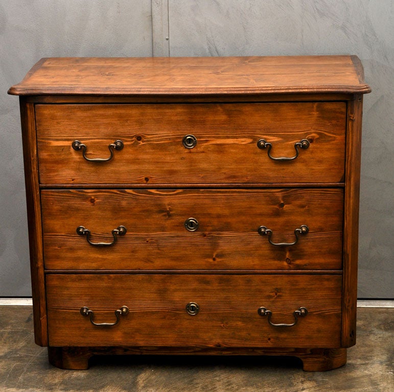 This commode is thought to be French, circa 1890, it has canted corners, a shaped top, three large drawers, six brass drop handles (5 1/2