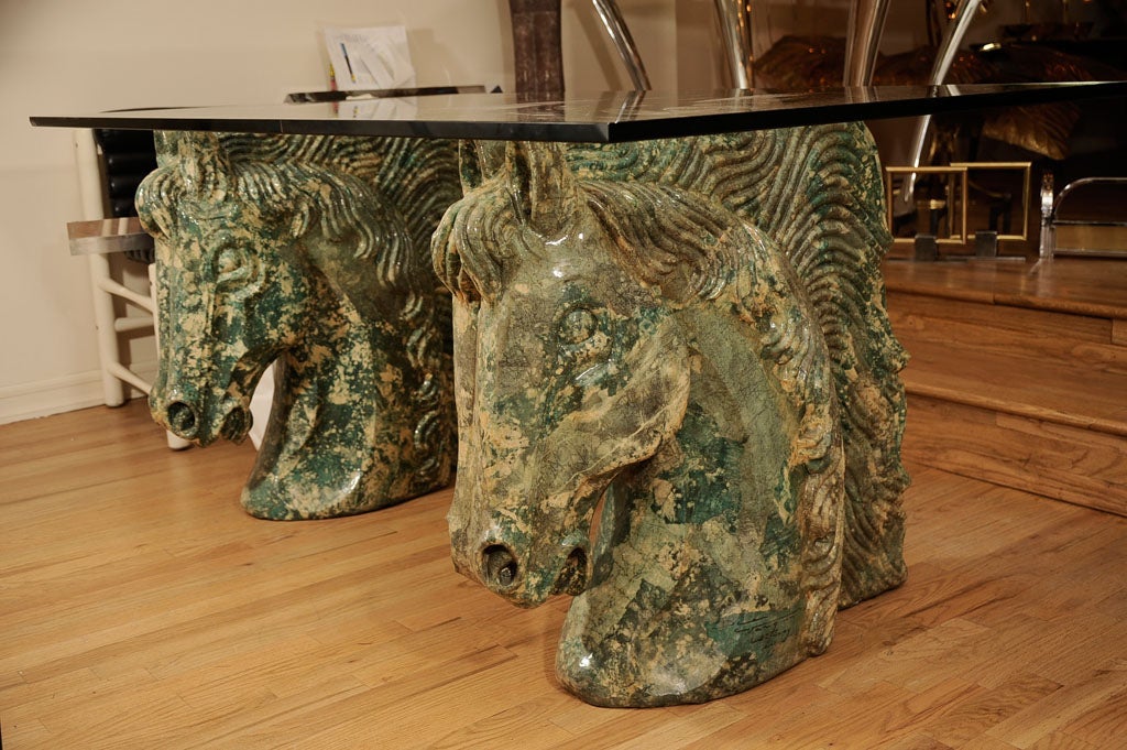 Pair of composition horse head form table bases with glass top