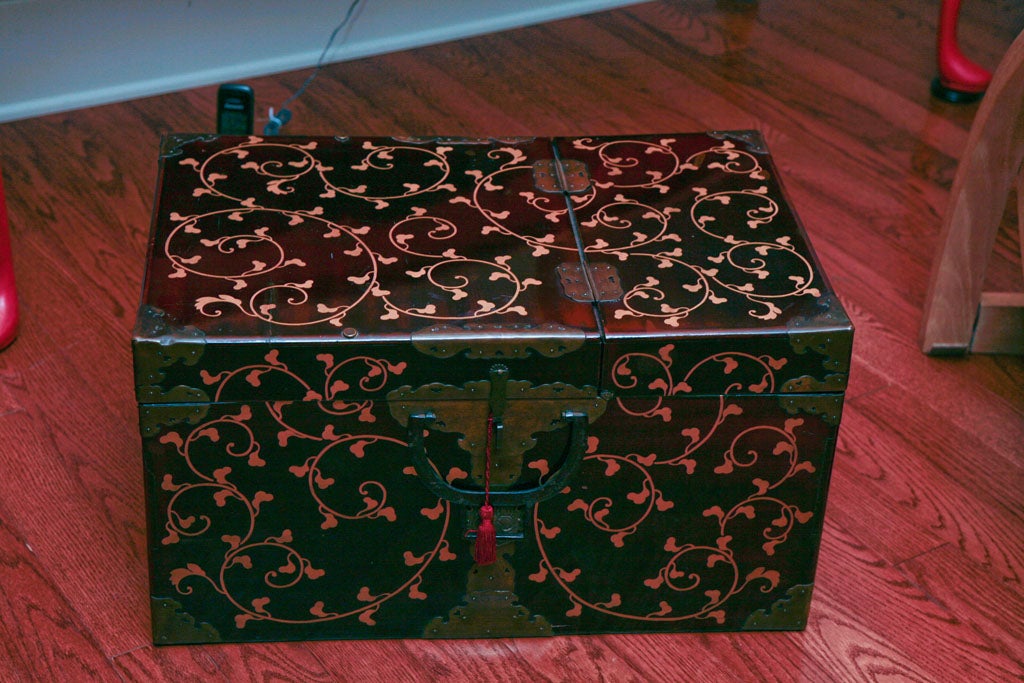 Black  lacquer garment box with gold vine design and family crest, circa 1850.