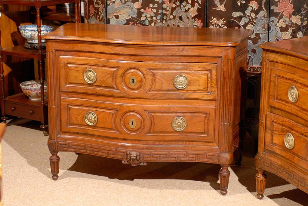 Pair of fine 18th century Italian  neoclassical serpentine figured walnut commodes with greek key and lion head carvings on apron and sides,  with  fluted detail on corners and legs. 

William Word Fine Antiques: Atlanta's source for antique