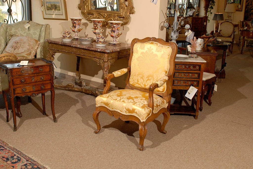 A fine Regence Period walnut fauteuil with shaped back and scallop shell carving, scrolled arms, shaped apron with similar shell detail, all resting on cabriole feet. The fauteuil dating in the early 18th century and Italian in origin. 

William