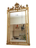 Antique French Louis XVI gold leaf cushion mirror.