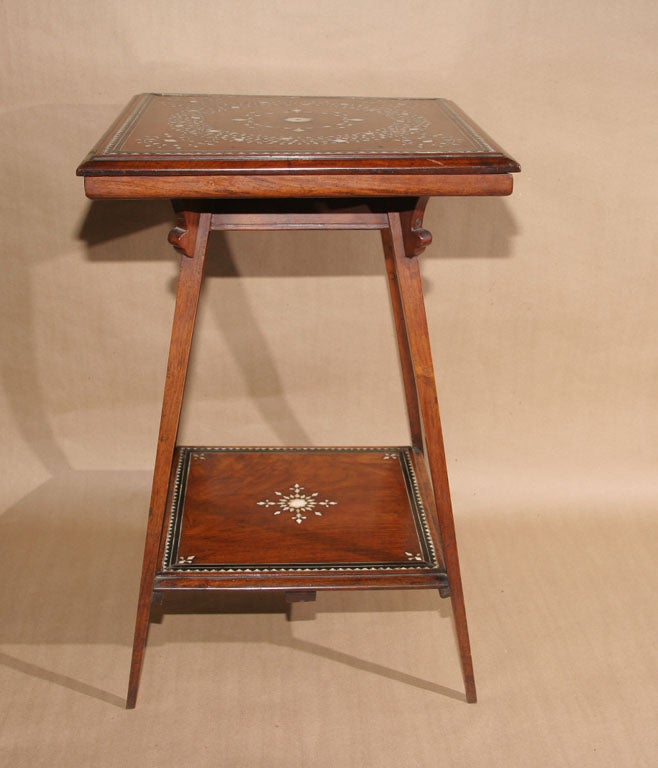 Anglo-Indian occasional table in sandalwood with ivory and ebony inlay, the top with geometric floral inlay over square tapered splay legs joined by star inlaid shelf.  Indian made for the English market