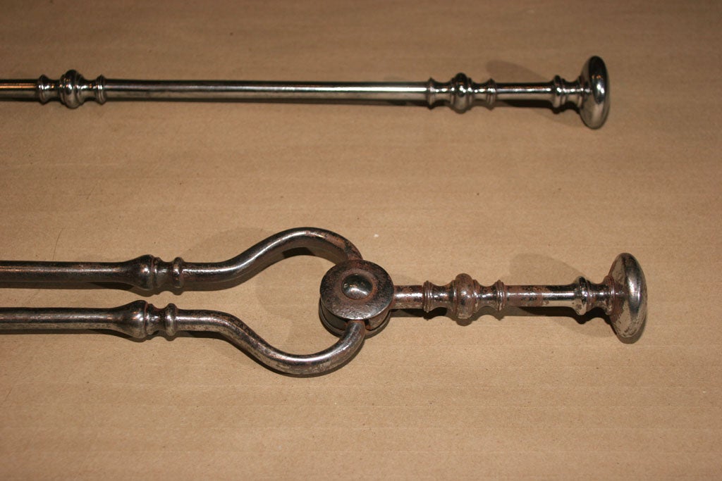 Fine set of three Georgian fire tools having square shovel with pierced rectangle decoration, flattened knob finials, the shafts with suppressed ball turnings.