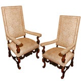 A pair of high-back Jacobean style walnut arm chairs