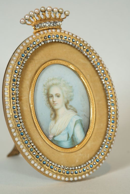 Offered here is an oval Jeweled Pearl Paste Gilt Antique Picture Frame with a ivory portrait.  Original back and brass easel.